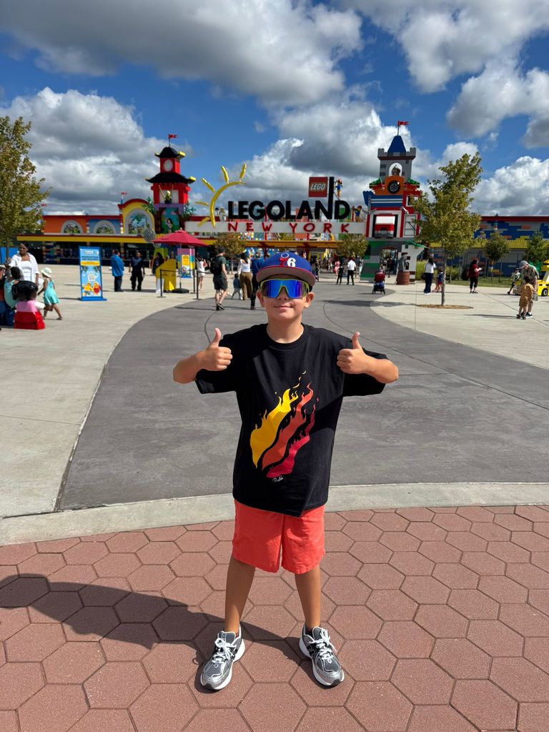 Andrii gives the thumbs up in front of Legoland