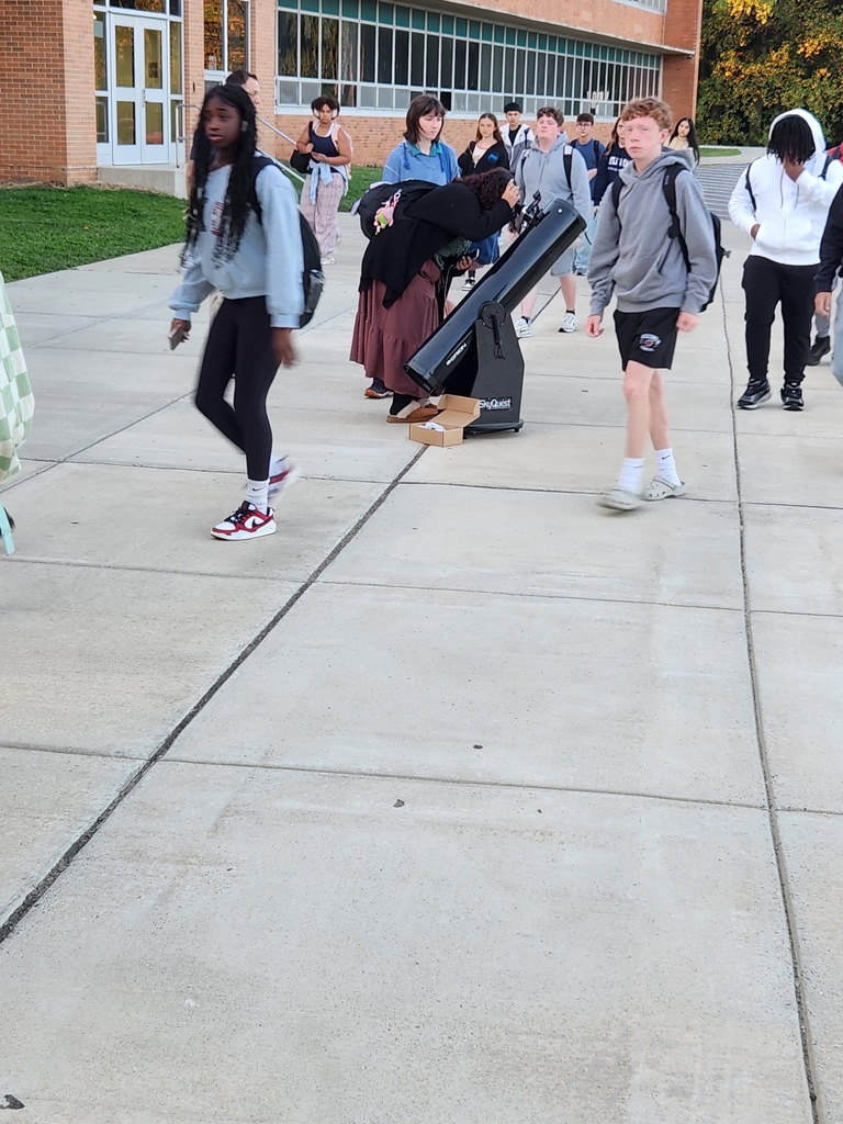 Mr. Anderson shows students the moon with his telescope