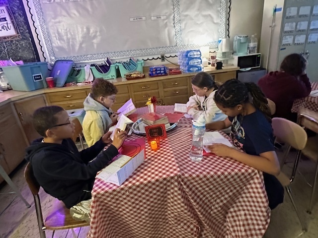 Students sampling books in class at the Book Tasting