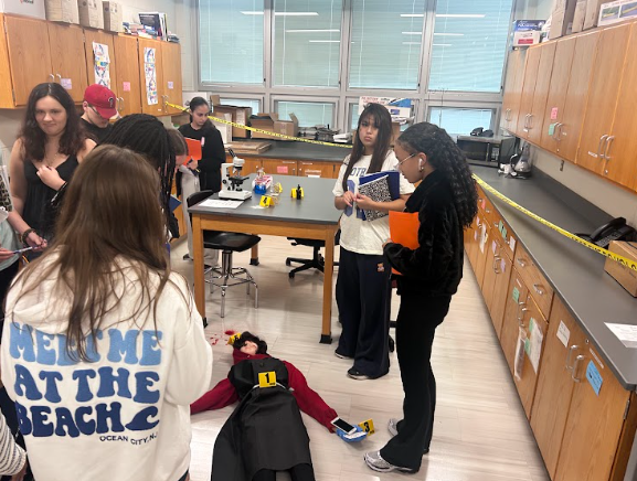 Students looking at fake dead body