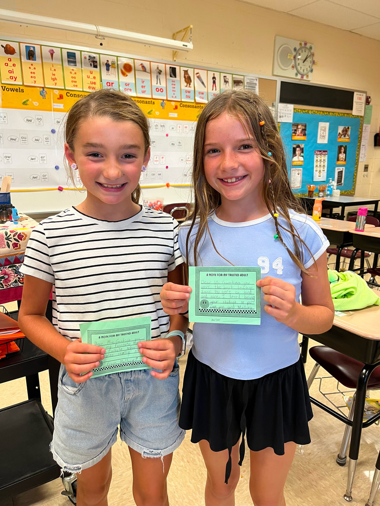 2 Overlook students hold notes of gratitude to "their trusted adults" during Start With Hello Week