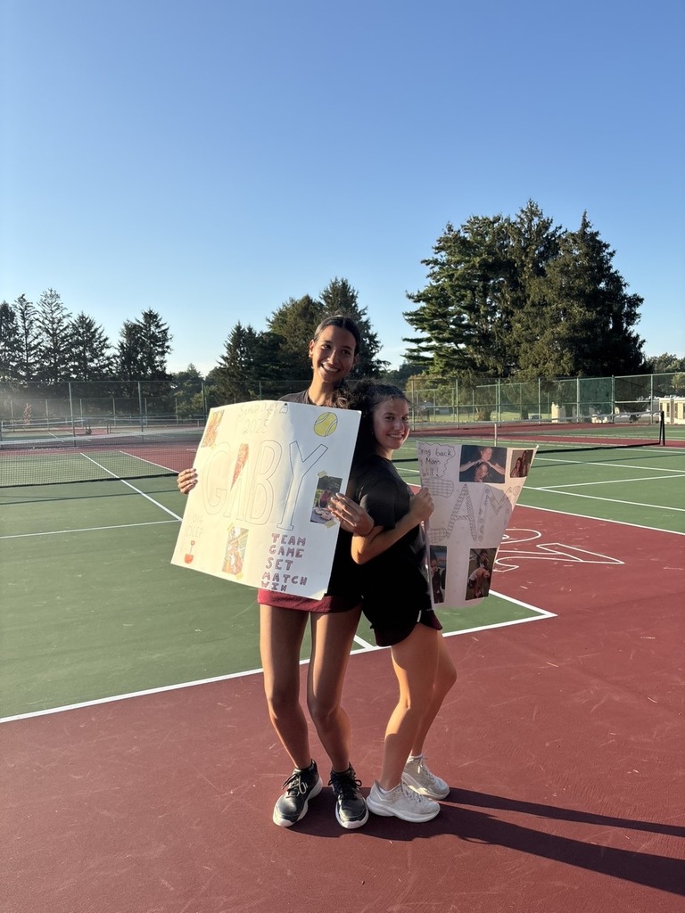Two of the tennis seniors posing for a picture 