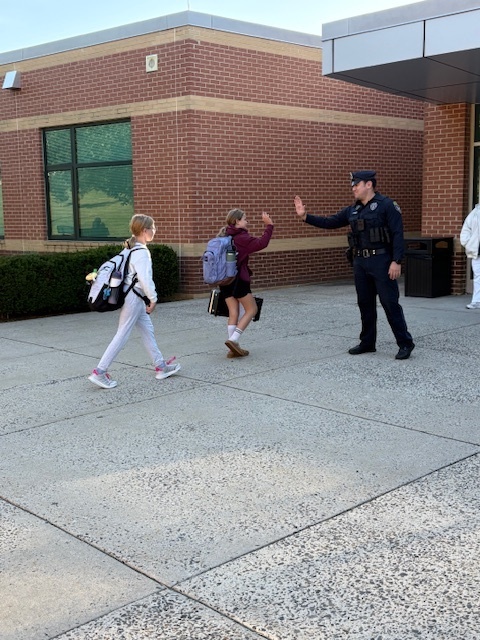 Officer Prior high fiving a student