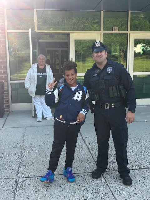 Officer Prior smiling with a student