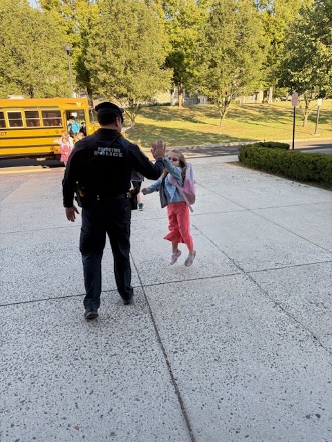Officer Prior high fiving a student