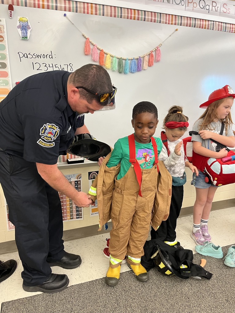 students trying on the firefighter gear