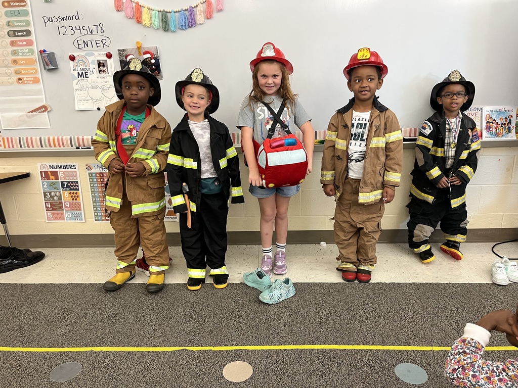 students smiling in firefighter gear