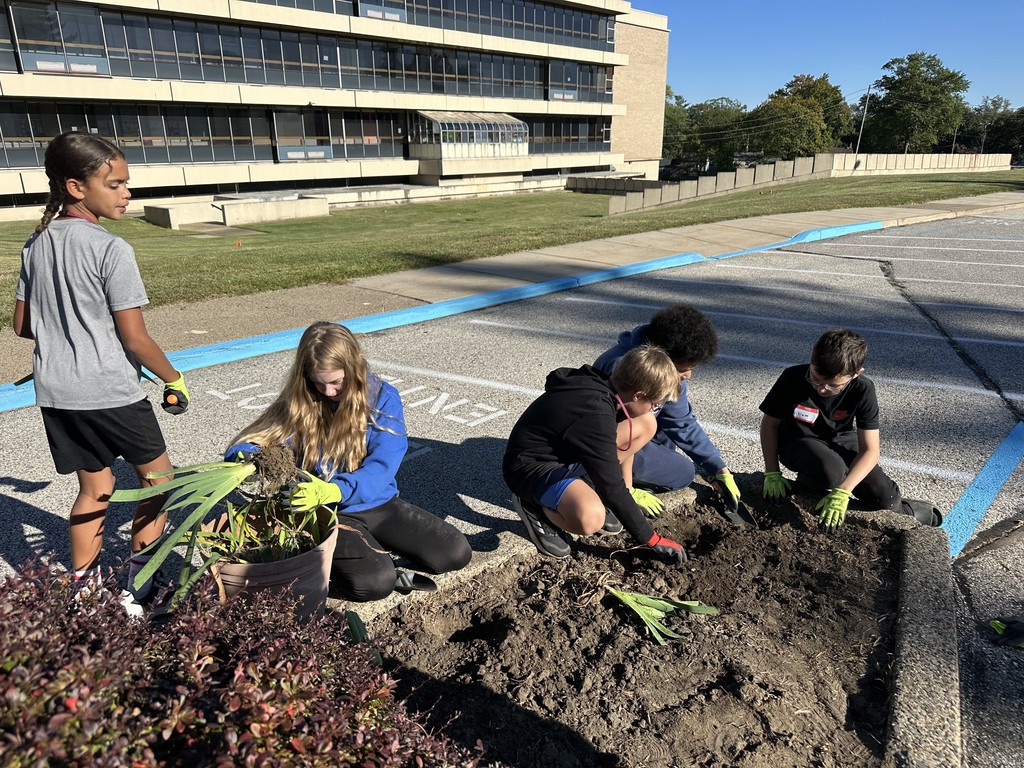 Image of students planting flowers.