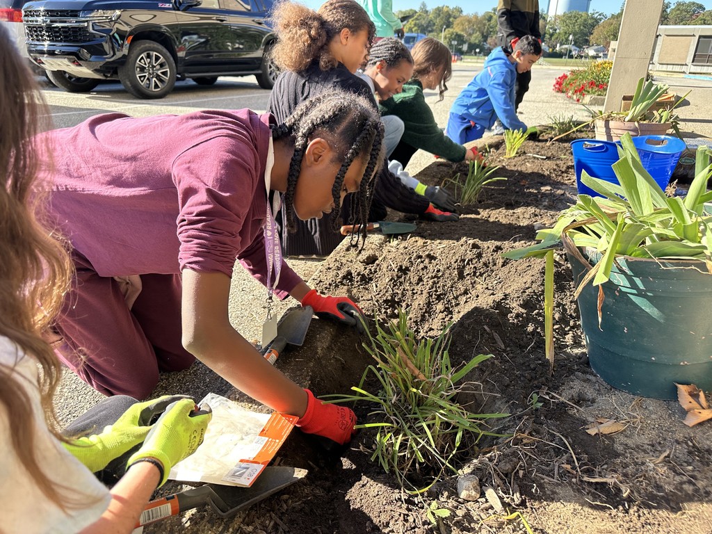 Image of students planting flowers.