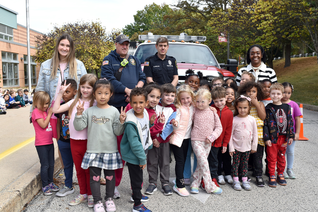 Overlook kindergarteners pose with their teacher, firefighters and Principal Boyd in front of the fire truck