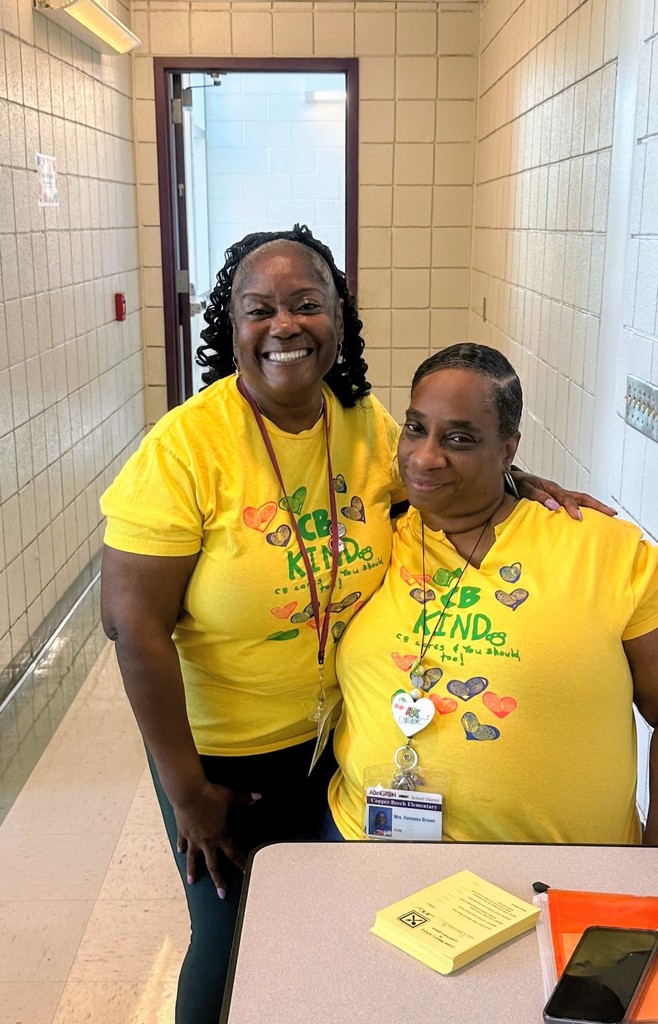staff smiling in matching outfits