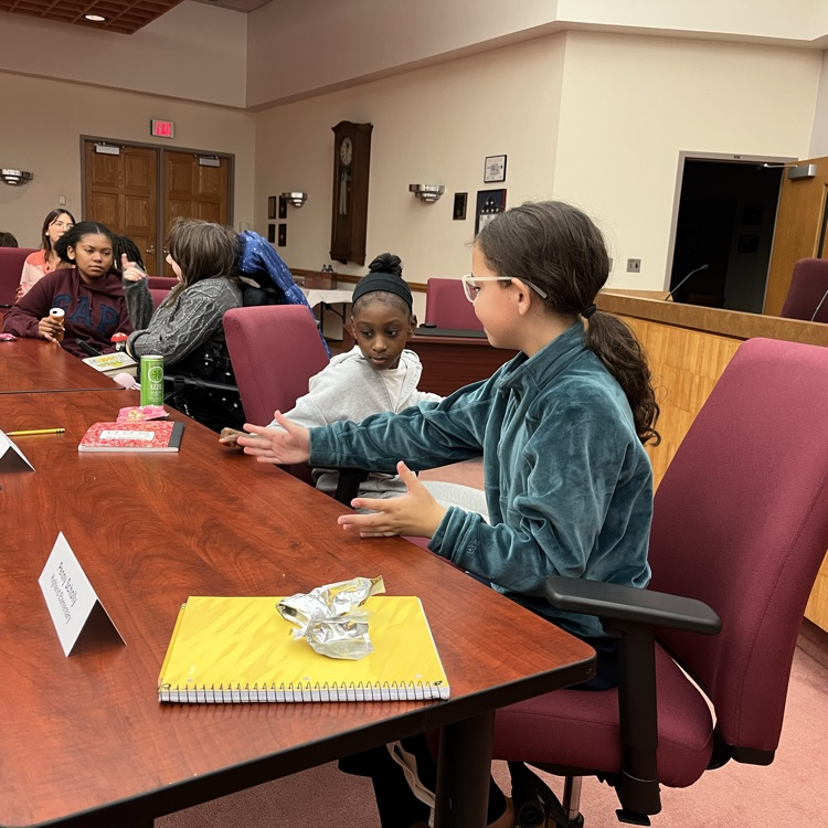 Students discuss and share feedback with Dr. Fecher and Dr. Melchor