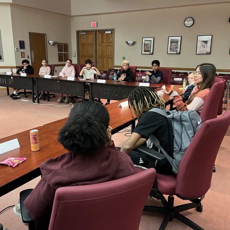 Students discuss and share feedback with Dr. Fecher and Dr. Melchor