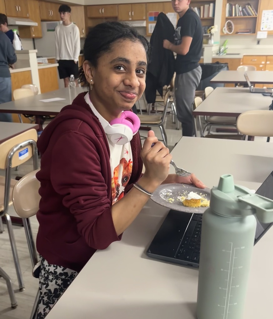 A beautiful girl enjoys cookies that she made herself.