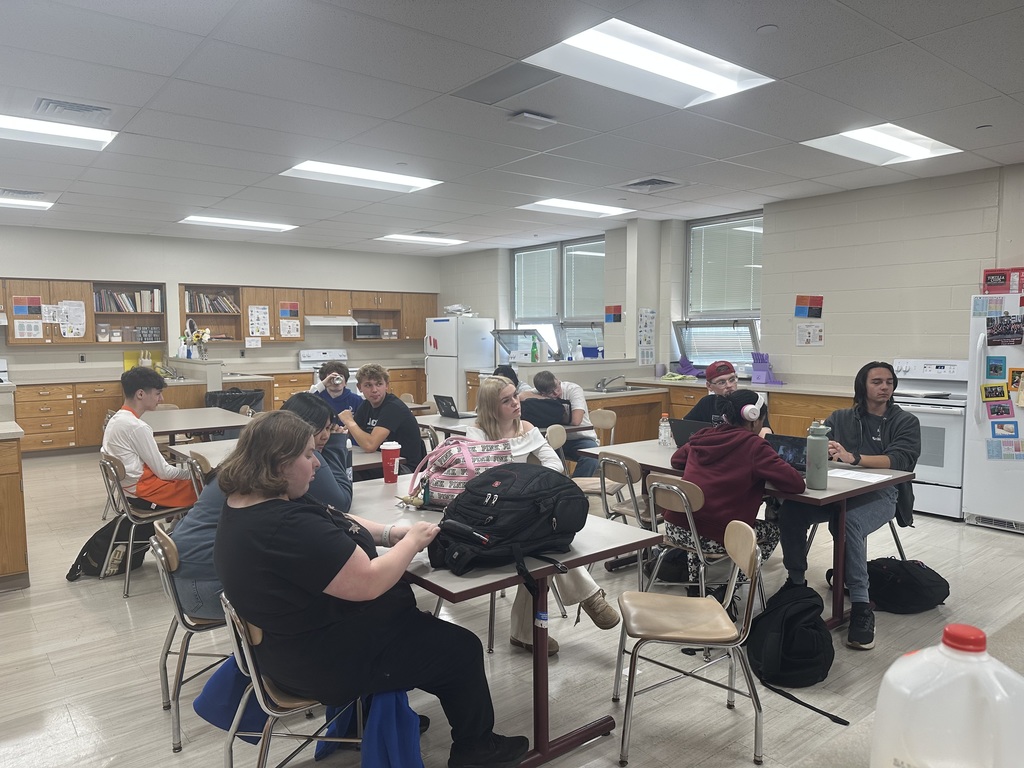 Students are attentively watching a movie about macaroni and cheese.