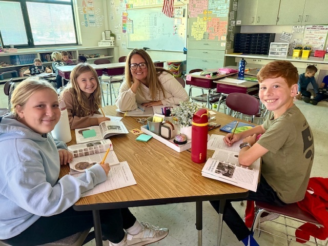 students smiling with their teacher