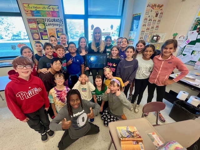 students smiling with Ms. Stokes