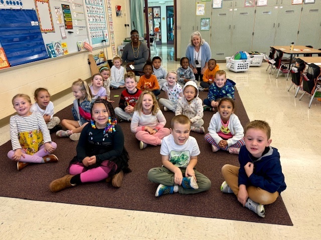 students smiling with staff