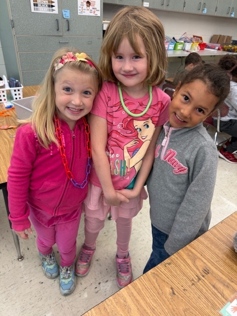 students smiling in pink