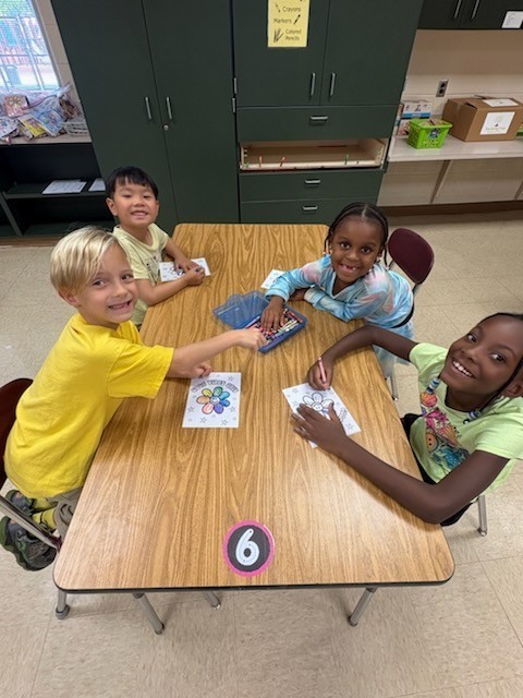 Overlook students sit at a table and make cards for those in need