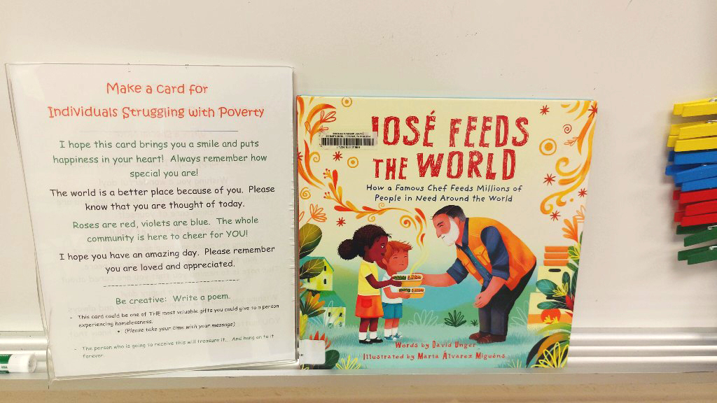 A book titled "Jose Feeds the World" and other literature about serving those in need