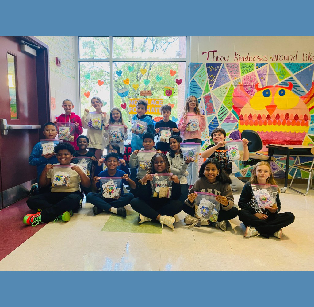 Overlook students pose as a class with the Belly Bags they filled with donated items for the needy