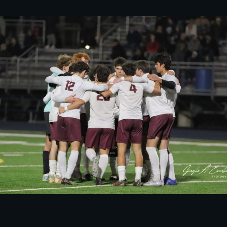 boys soccer team huddled together