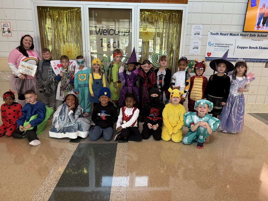 students in their Halloween costumes smiling