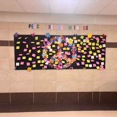 Peace begins with us poster on wall