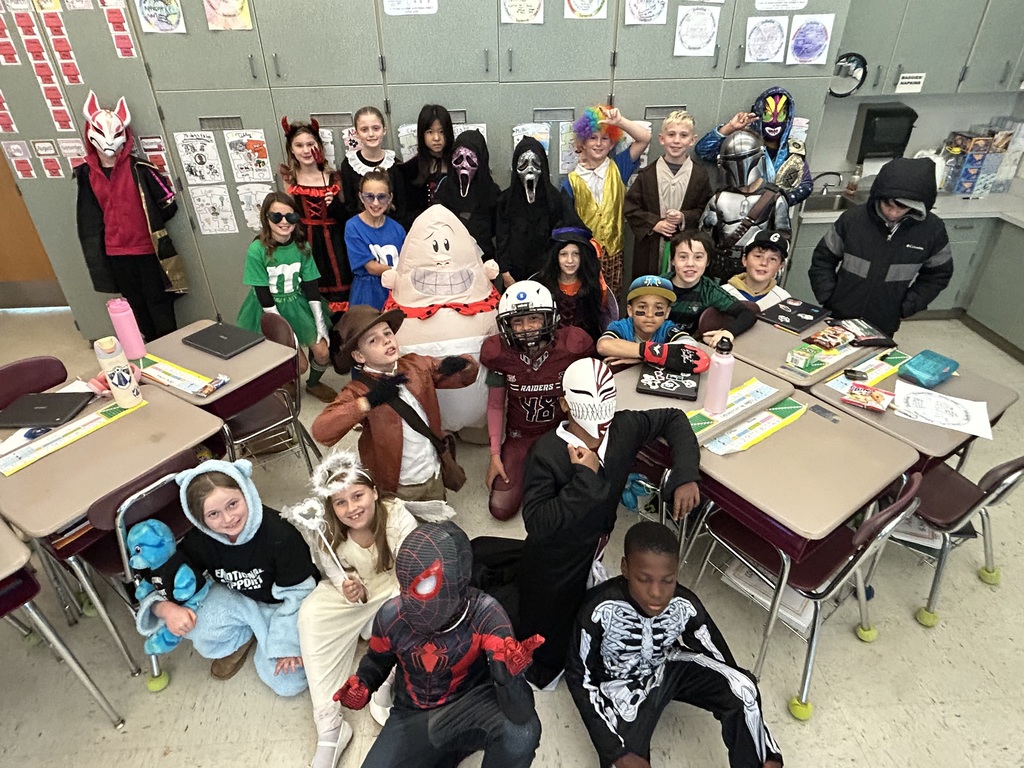 students smiling in their Halloween costumes