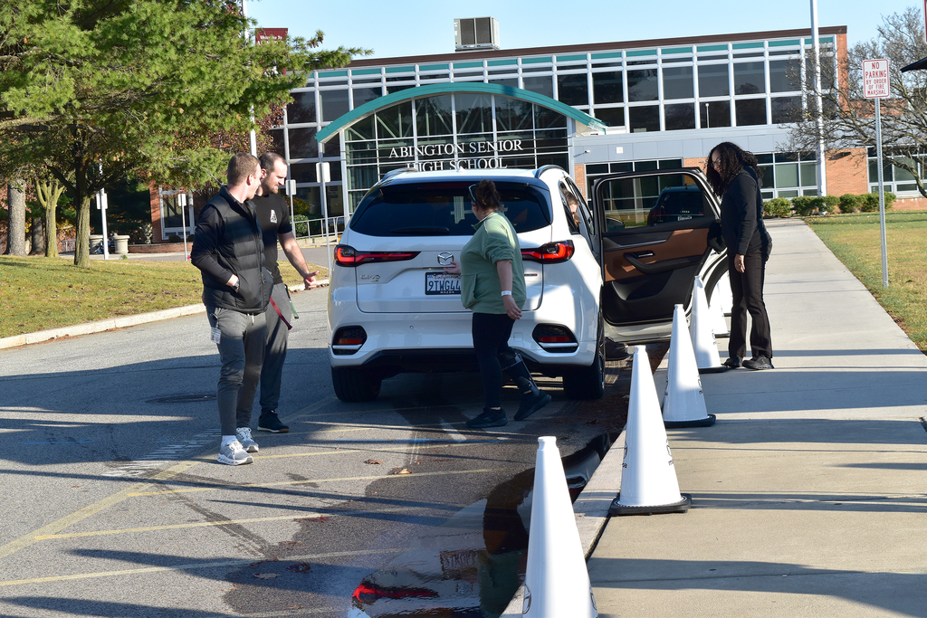 Teachers and staff get ready to test drive the Mazda vehicles