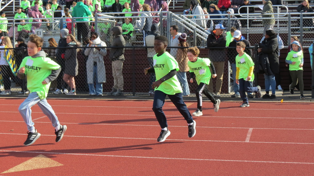 Students entering the track for their event.
