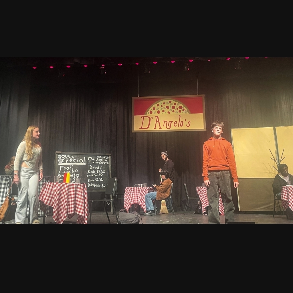 Actors on stage in the restaurant set