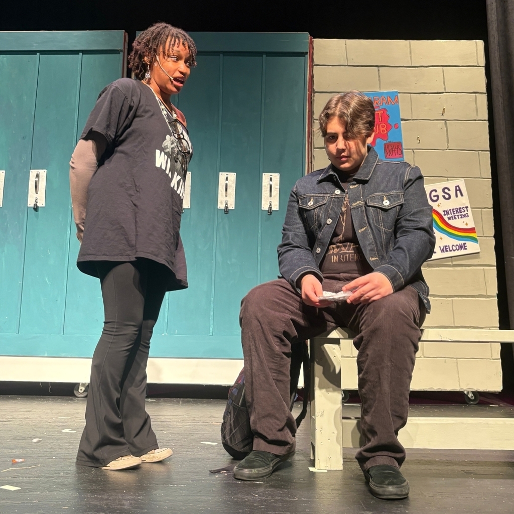 Actors on stage in the hallway set