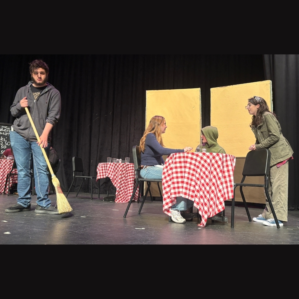 Actors on stage in the restaurant set