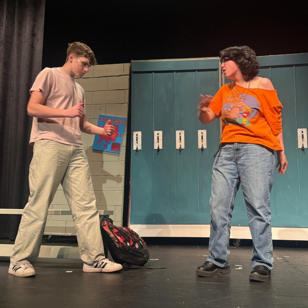 Actors on stage in the hallway set