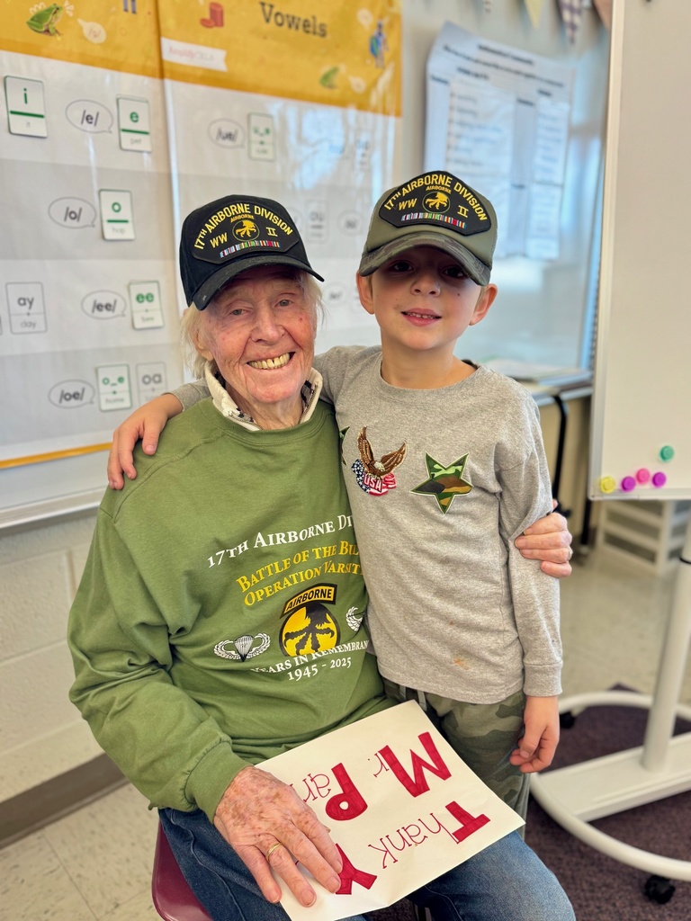 Student smiling with a veteran