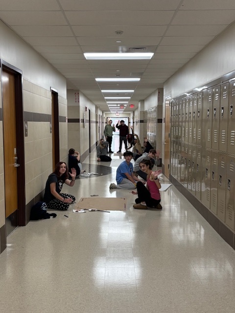 students painting signs