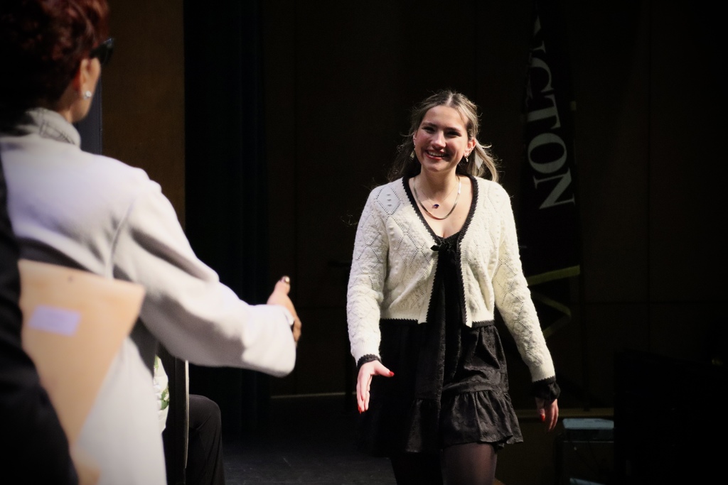 An NHS inductee walking onstage