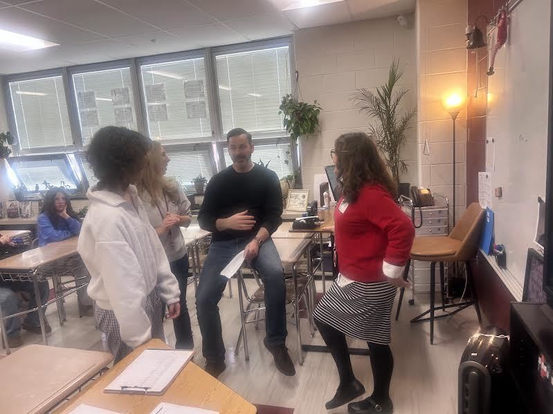Maddie Krassner, Mr. Kulp, Ms. Martin, and Dr. Schmidt stand in a circle talking to Dr. Schmidt 