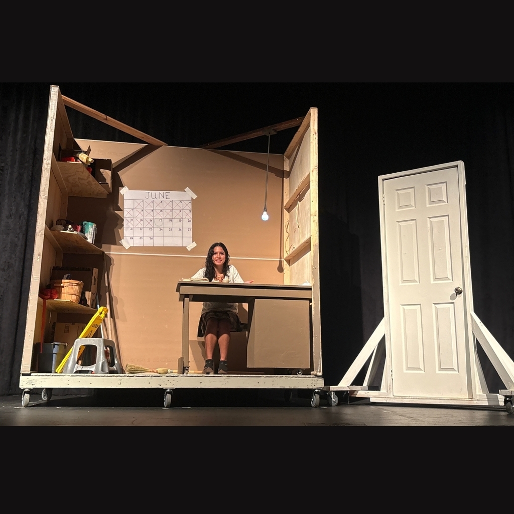 Actor on stage in the broom closet set