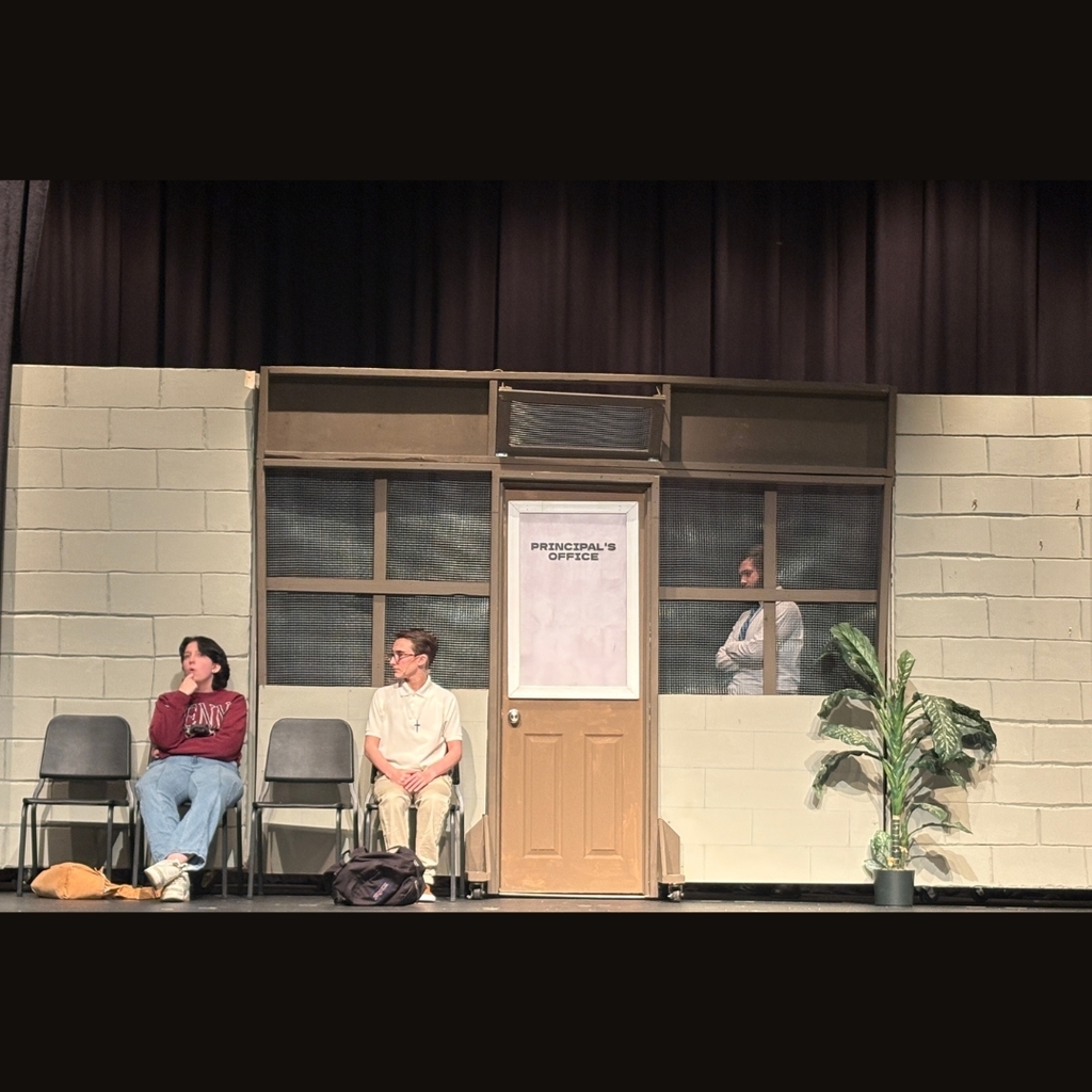 actors on stage outside the principals office set