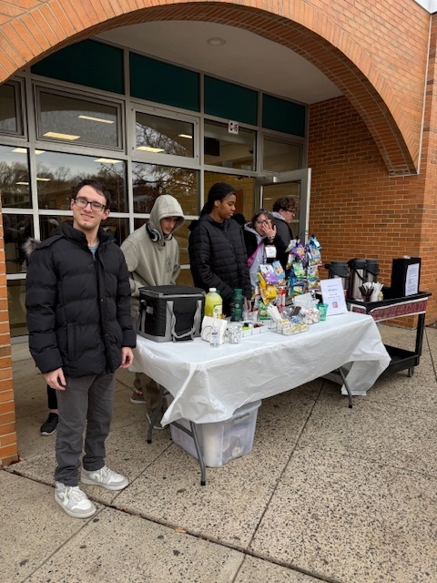 Active Academy and STRIVE students stand ready to serve beverages, with coffee and handmade items to offer