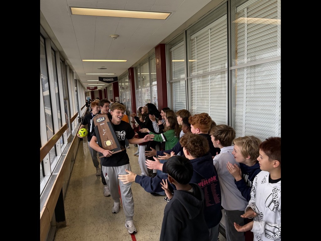Soccer team walks through the halls of AMS