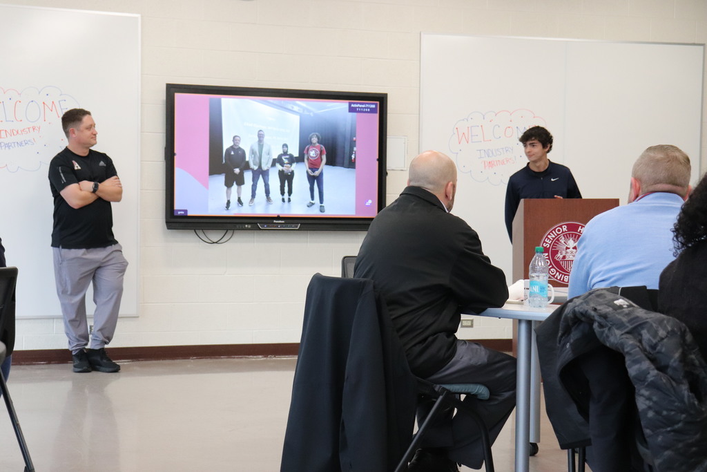 Students and staff present to the industry partners about their positive experiences with the program