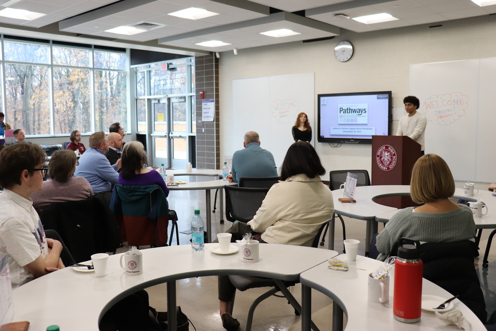 Students and staff present to the industry partners about their positive experiences with the program
