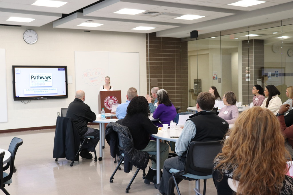 Students and staff present to the industry partners about their positive experiences with the program