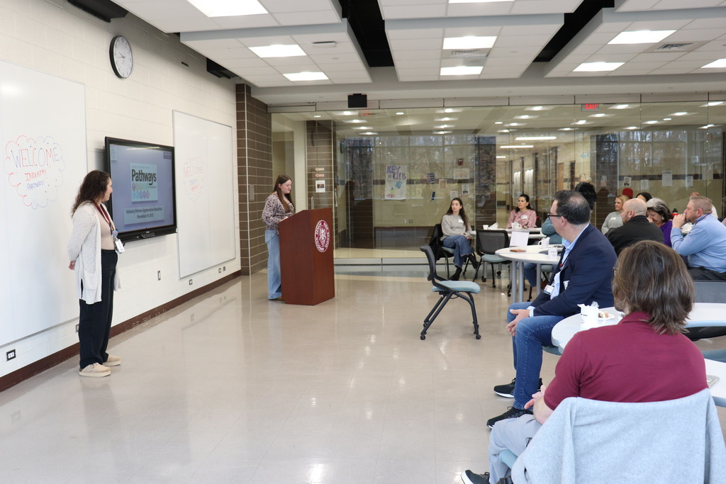 Students and staff present to the industry partners about their positive experiences with the program