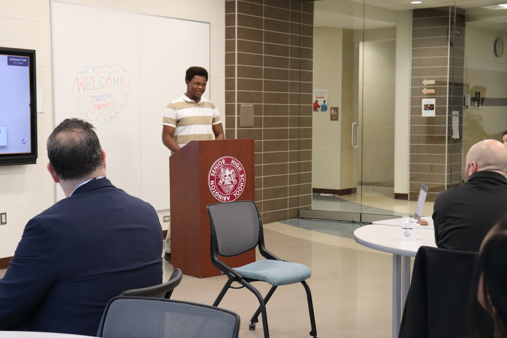 Students and staff present to the industry partners about their positive experiences with the program