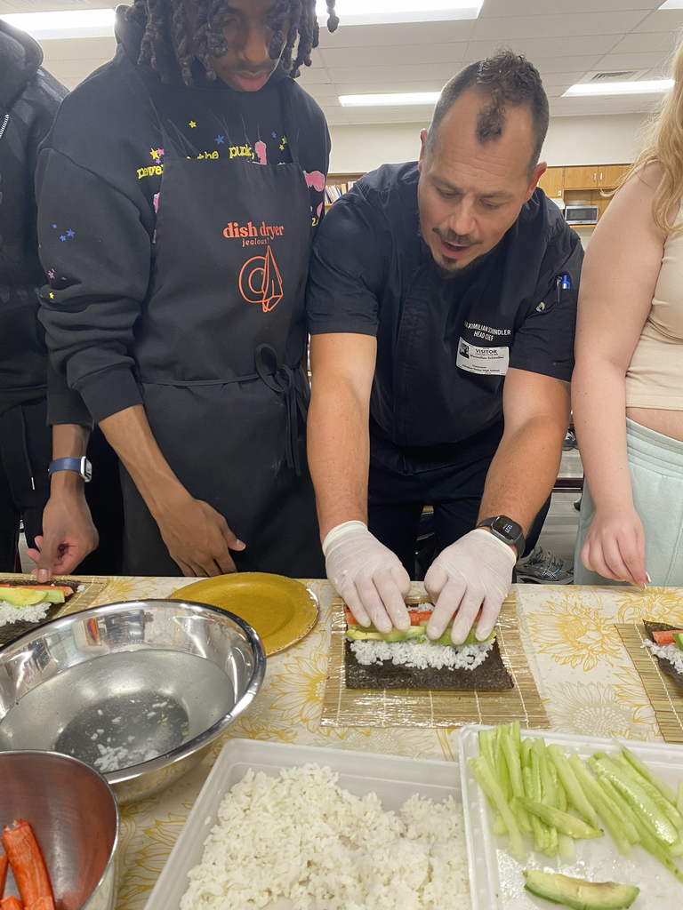 Chef Schindler demonstrates sushi rolling for students